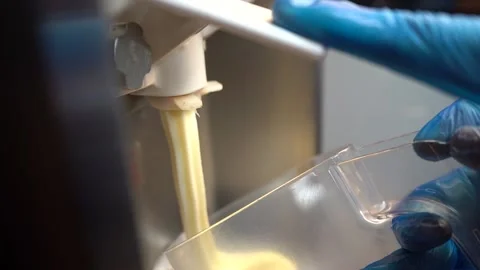 Ice Cream Pouring Into Plastic Container Stock Footage 146228433