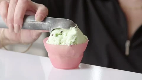 Ice cream scoop going in to a container Stock Footage 245468847