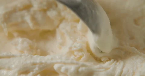 Ice cream scooping out of container by metal spoon in slow motion 4k video Stock Footage 101275644