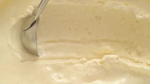 Ice cream scooping out of container by metal spoon close up Stock Footage 121682678