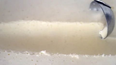 Ice cream scooping out of container by metal spoon close up Stock Footage 124592089