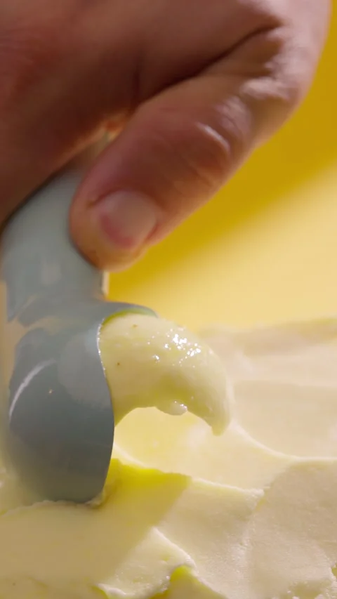 Ice cream scooping. Scoop vanilla ice cream. Vertical close-up Stock Footage 311546287