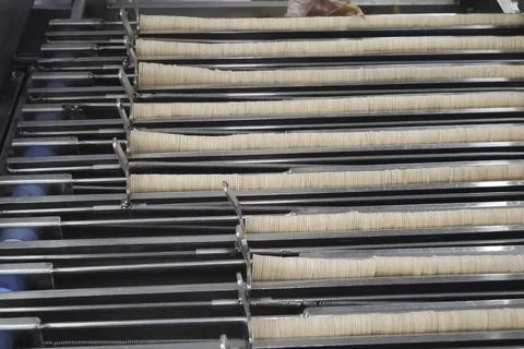 Ice cream sticks in stack on a conveyor line in an ice cream factory. Stock Photos