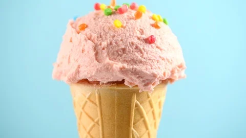 Ice cream. Strawberry or raspberry flavor icecream in waffle cone rotated Stock Footage 87999921