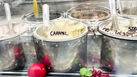 Ice cream of various flavors inside metal containers Stock Footage 259340313