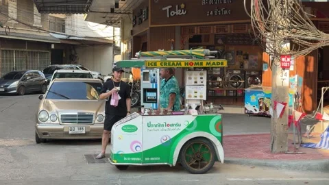 Ice-cream vendors chit-chat with customers on Yaowarat Road. Stock Footage 346956202