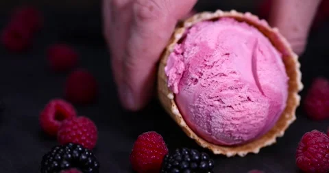 Ice cream in a waffle cone on a black background, delicious sweet cold Stock Footage 301041887