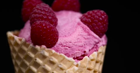 Ice cream in a waffle cone , delicious sweet cold raspberry-flavored ice cream Stock Footage 296794559