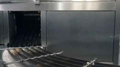Ice cream waffle cones arrive on rotating equipment in shop Stock Footage 124170168