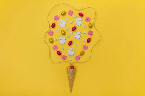 Ice cream waffle horn with Easter decoration wooden flowers, rabbits and eggs on Stock Photos