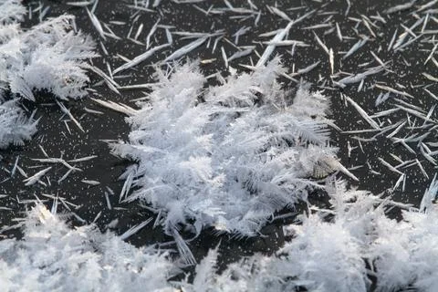 Ice crystals on dark ice Stock Photos