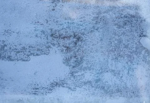 Ice crystals forming delicate patterns on a frozen window Stock Photos