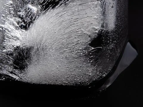 Ice cube on black background. Close up real melting ice cube. Stock-Fotos