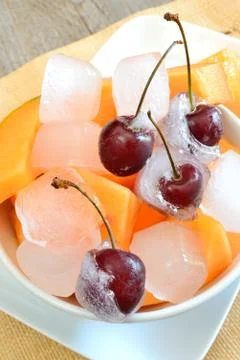 Ice cube cherries Stock Photos
