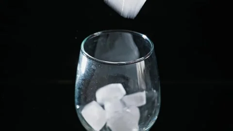 Ice Cube Dropping Into Empty Wine Glass Against Black Background Stock Footage 339366120