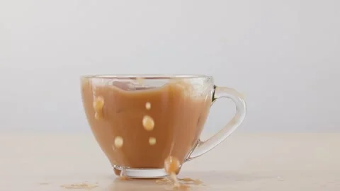 Ice Cube Dropping into Glass Cup of Iced Coffee with Milk Stock-Footage 341456647