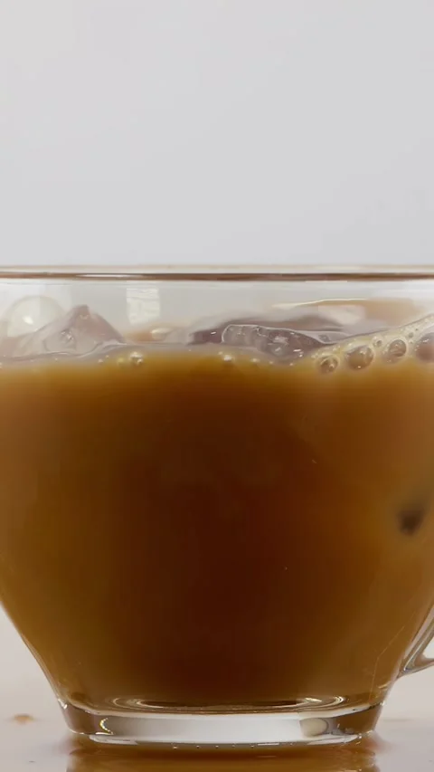 Ice Cube Falling into Glass Cup of Iced Coffee with Splash Видео 342691149