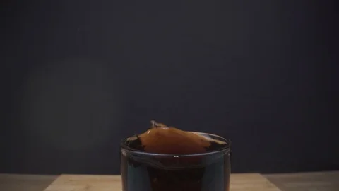 Ice cube falling into glass Macro wide shot sliding over 動画素材 124018409