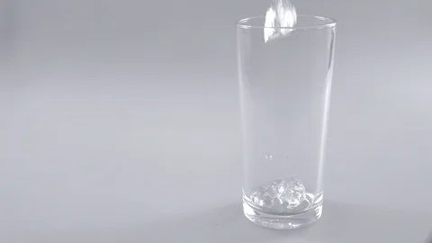 Ice cube falling in glass slow motion Stock Footage 102216208