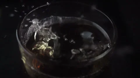 Ice Cube Falling Into A Glass Of Whiskey and Coke Stock-Footage 60782216