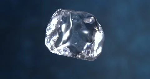 Ice cube falling in slow motion on blue background Stock Footage 346367365
