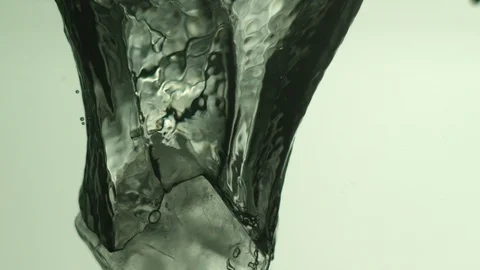 Ice Cube Falling Into Water Video stock 104374709