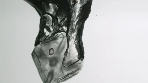 Ice cube falling into water Video stock 104645171