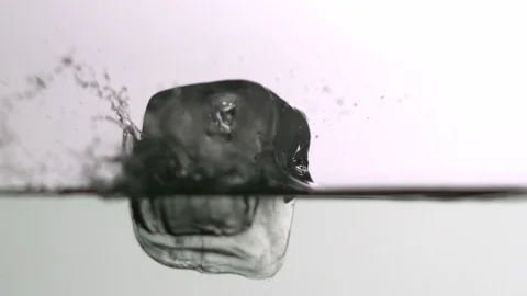 Ice cube falling into water Video stock 104649856
