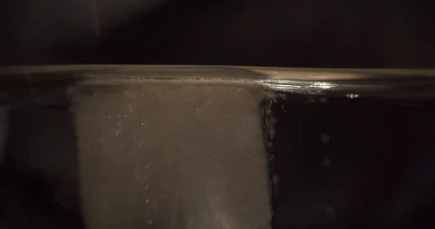 Ice Cube Floating Macro Closeup Stock Footage 128162804