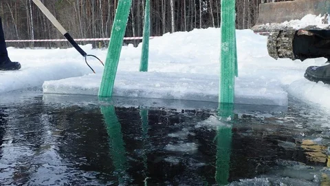 Ice cube lifted up from ice hole with slings Stock Footage 88203285