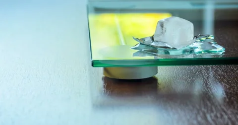 Ice cube melt on glass surface. Slow zoom in shot 库存影片 66876972