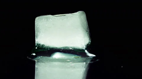 Ice Cube Melting and Moving on a Glass Surface Stock Footage 59651102