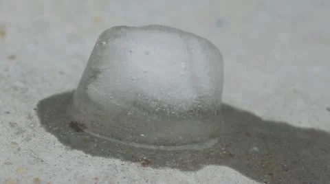 Ice cube melting on concrete Stock Footage 22212374