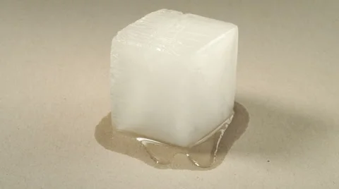 Square melting ice cubes on wet table Stock Photo by FabrikaPhoto