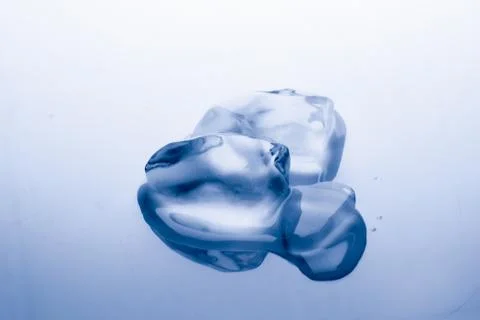 Ice cube melts in studio: Global warming concept Stock Photos