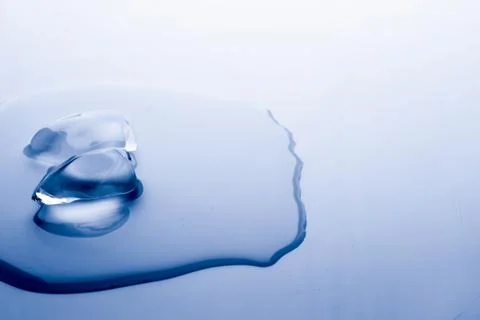 Ice cube melts in studio: Global warming concept Stock Photos