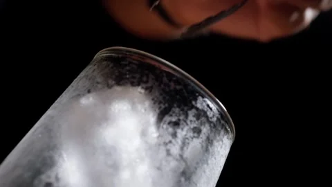 Ice Cube Placed into Chilled Fluted Glass with Metal Tongs Stock Footage 337862607