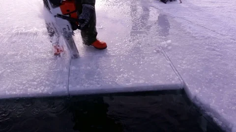 Ice cube released with a chainsaw at a frozen lake in Finland Stock Footage 72773250