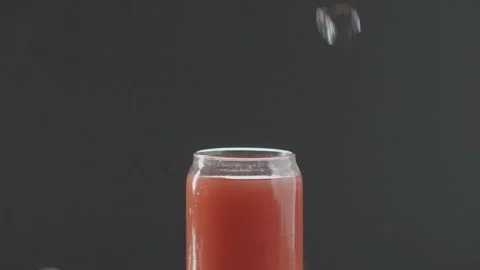 Ice cube slowly falling into summer fruit cocktail Stock Footage 97754354
