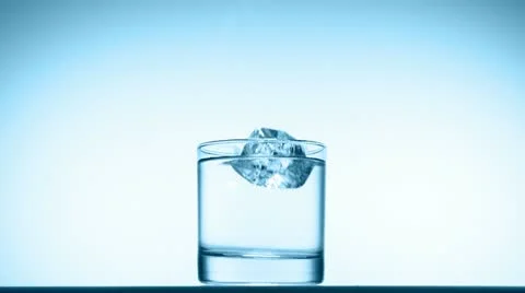Ice cube splash in glass of water, slow motion Stock Footage 20608302