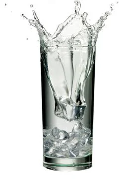 Ice cube splashed in glass of water Stock Photos