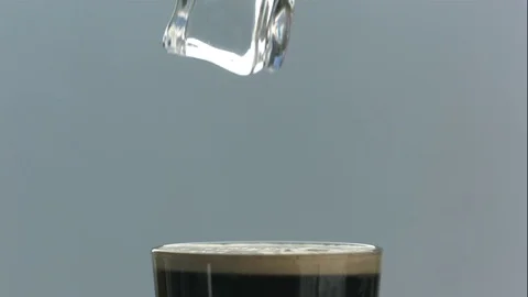 Ice Cube Splashes Into Glass of Nitro Cold Brew Coffee in Slow Motion 스톡 동영상 75115768