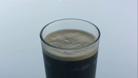 Ice Cube Splashes Into Glass of Nitro Cold Brew Coffee in Slow Motion Stock Footage 75117059