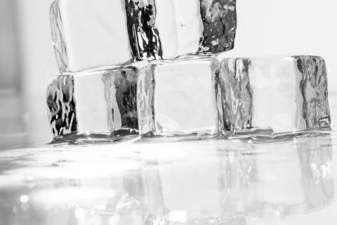 Ice cube on table Fotos Stock