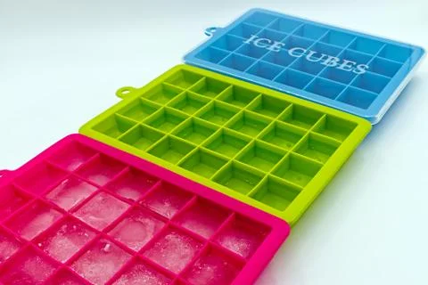 Ice cube tray of different colors, isolated on white background Stock Photos