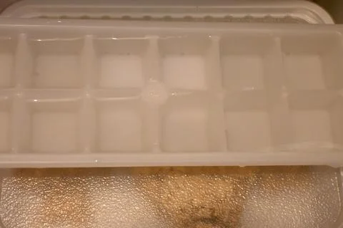 Ice cube tray in a freezer Stock Photos