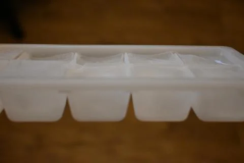 Ice cube tray on a table Stock Photos