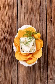 Ice cube wrapped in golden chips with herbs Fotos Stock