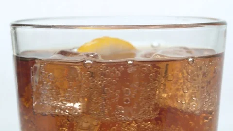 Ice cubes and lemon slice in the glass of cola Stock Footage 124039027
