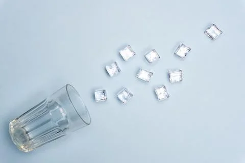 Ice cubes and stack on a blue background isolated. Clean water creative. Minimal Stock Photos